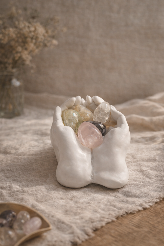 Healing crystal trio displayed in open hands symbolising comfort and support.
