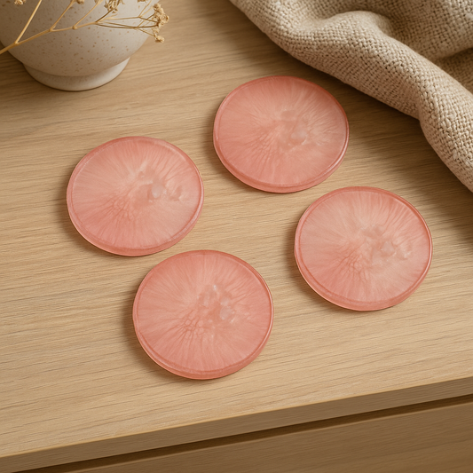 Handmade blush pink resin coaster with clear quartz detailing, circular shape.