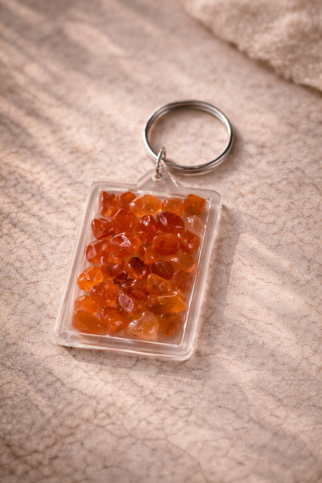 Pocket Energy Keyring filled with carnelian crystal chips to support confidence and motivation.